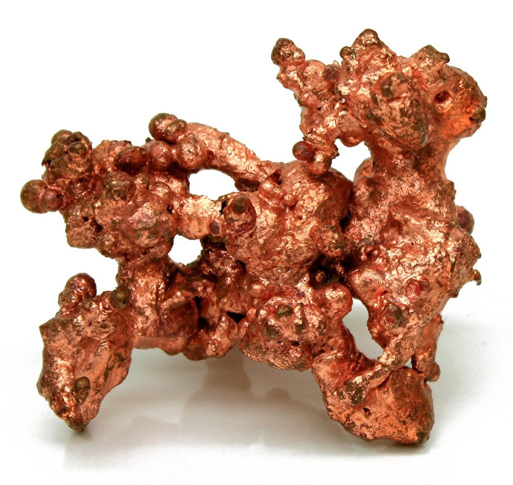 Image of an irregular lump of copper colored ore.